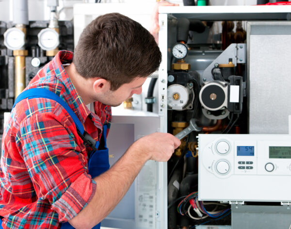 Technician servicing heating boiler